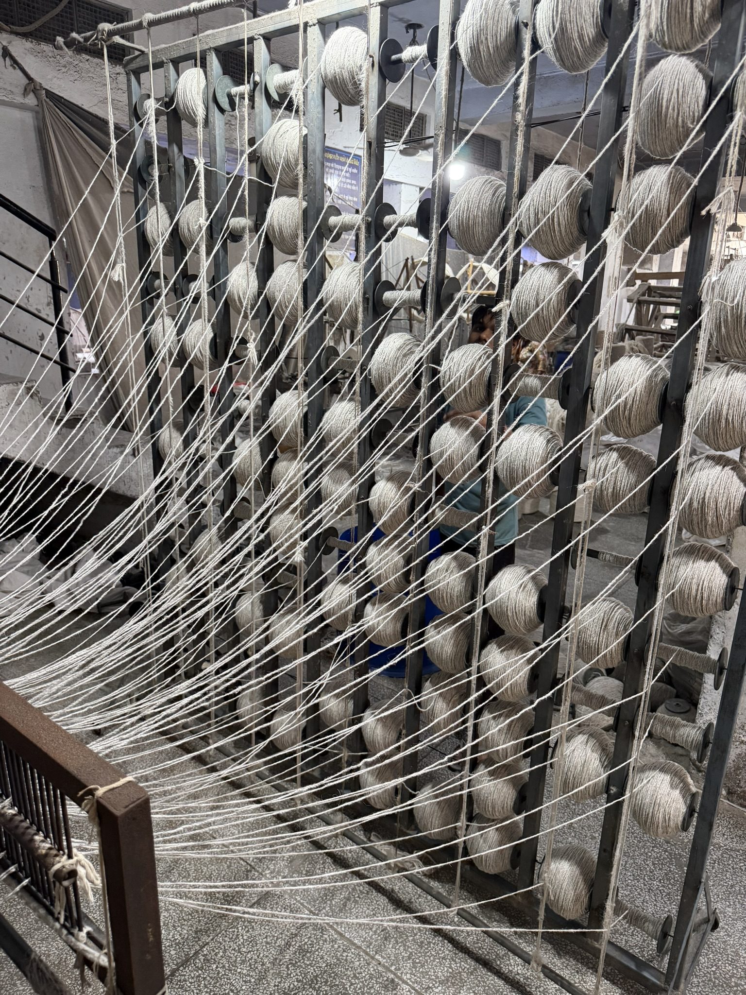 Hand weaving a wool carpet on the loom